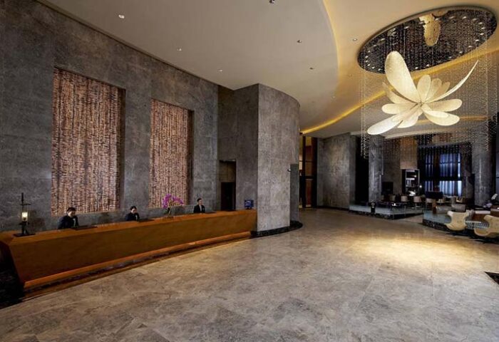 Carlton City Hotel Singapore lobby. Gay-friendly hotel with modern design, reception desk, and stylish lighting. A welcoming space for gay travelers.