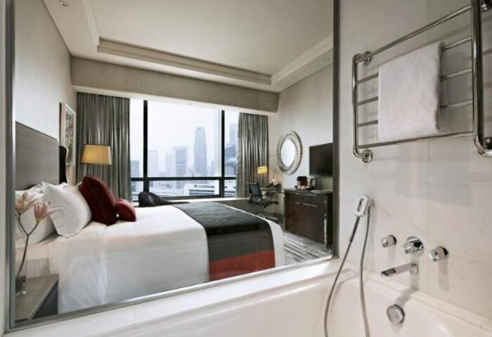 Carlton City Hotel Singapore room view from bathroom. Gay-friendly hotel offers modern rooms, city views. Perfect for gay travel in Singapore.