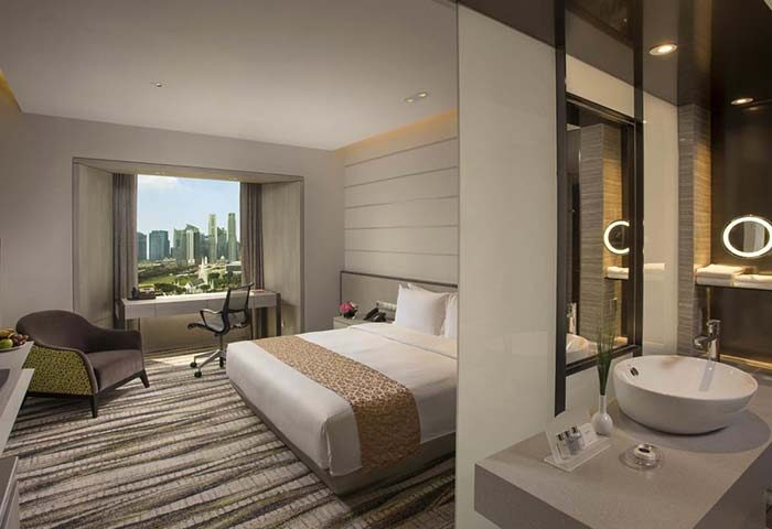 Carlton Hotel Singapore room with city view. Gay-friendly hotel with modern design. Comfortable bed, desk, and bathroom. Ideal for gay travelers.