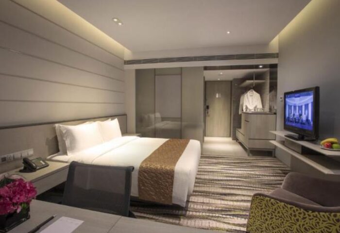 Carlton Hotel Singapore room. Gay-friendly hotel with a bed, desk, and TV. Ideal for gay travelers seeking comfort in Singapore.