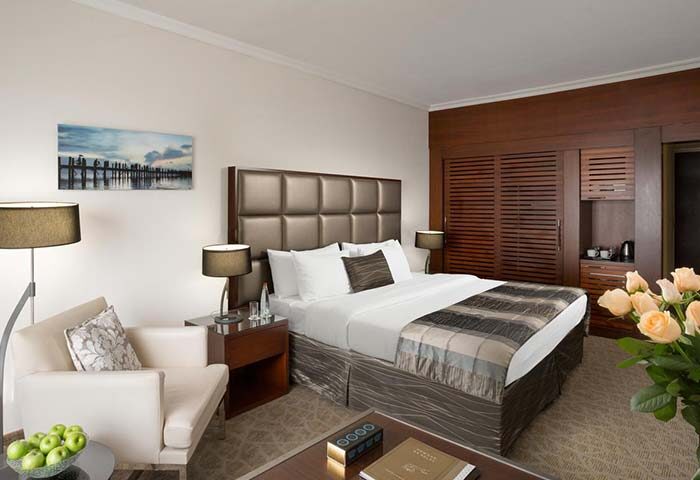 Carlton Tel Aviv Hotel luxury room. Gay-friendly hotel on the beach, featuring a king-size bed, modern decor, and a relaxing atmosphere.