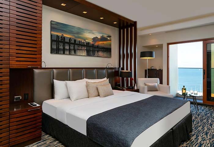 Carlton Tel Aviv Hotel luxury room. Gay-friendly hotel on the beach with ocean view. Upscale decor, king bed, and balcony.