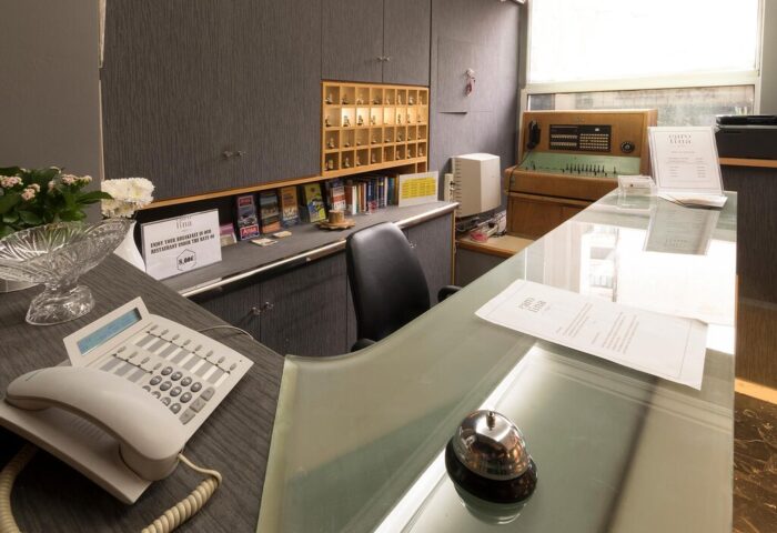 Carolina Hotel reception area. Gay-friendly hotel with a vintage switchboard, room keys, and a bell. A unique hotel for gay men travelers.