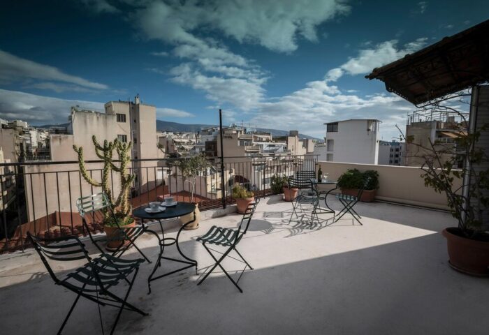 Rooftop view at the Carolina Hotel, a gay-friendly hotel. Table and chairs offer a relaxing space with city views. #gaytravel #hotel