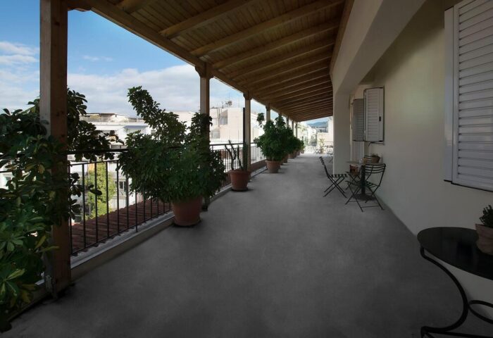 Carolina Hotel's balcony view. This gay-friendly hotel offers a relaxing outdoor space with potted plants and seating, perfect for gay men travelers.