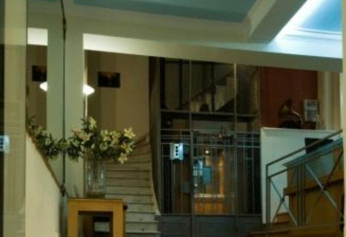 Carolina Hotel's interior: Stairs lead up past a flower arrangement in this gay-friendly hotel. A gate blocks access to the stairs.