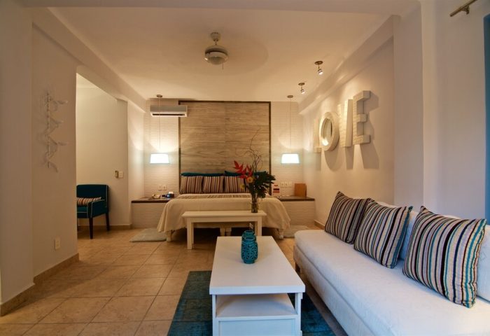 Casa Cupula, gay-friendly hotel suite. Bedroom with LOVE art, sofa, and king bed. Gay travel luxury in Puerto Vallarta, Mexico.