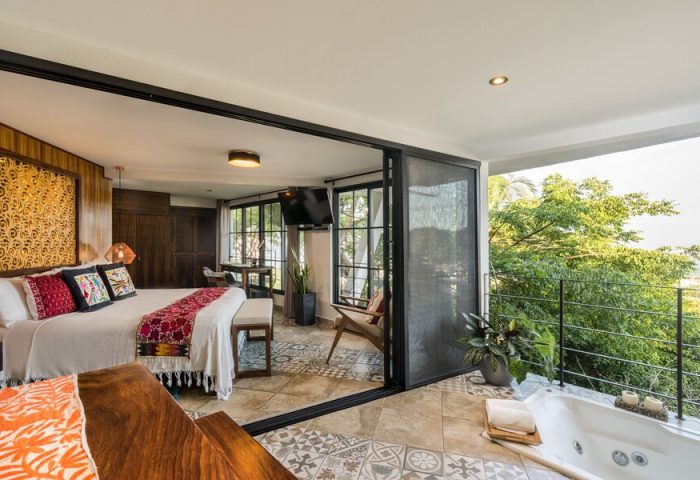 Casa Cupula gay-friendly hotel suite. Bedroom with balcony, jacuzzi, and view of Puerto Vallarta. Luxury gay travel vacation.
