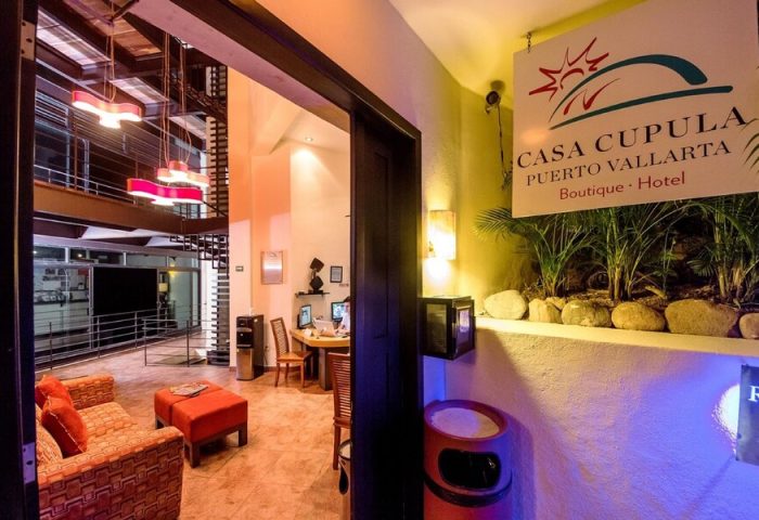 Casa Cupula, a gay-friendly hotel in Puerto Vallarta. Lobby view with modern decor, seating area, and reception desk. Boutique hotel ambiance.