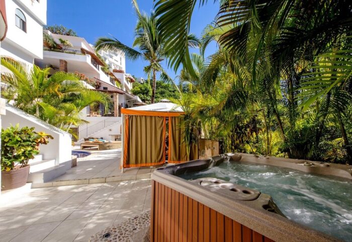 Casa Cupula, a gay-friendly hotel. Hot tub and cabana surrounded by lush greenery. Perfect for gay travel in Puerto Vallarta.