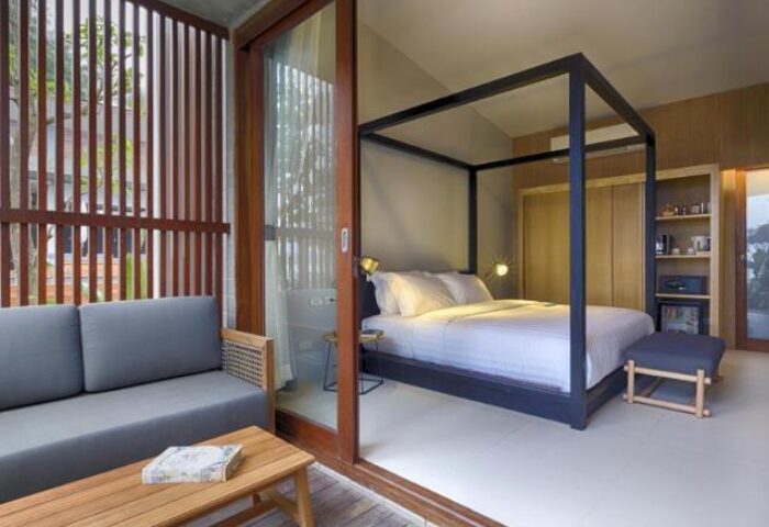 Casa De Mar Hotel room. Gay-friendly hotel featuring a four-poster bed, sofa, and balcony. Modern design, perfect for gay men's travel.