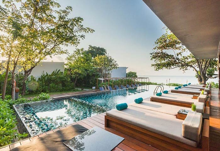 Casa De Mar Hotel's pool view. Gay-friendly hotel with sunbeds, ocean view, and lush greenery. Perfect for gay men's travel.