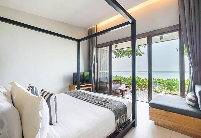 Casa De Mar Hotel's gay-friendly room with a four-poster bed and ocean view. Relax on the patio of this gay hotel.