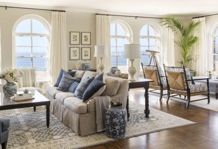 Casa Del Mar gay-friendly hotel living room. Beach view from arched windows, sofa with blue pillows, and stylish decor. Luxury gay travel.