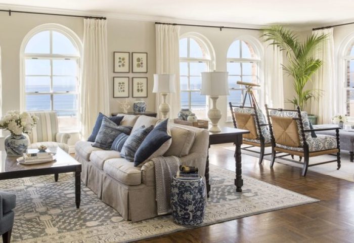 Casa Del Mar gay-friendly hotel living room. Beach view from arched windows, sofa with blue pillows, and stylish decor. Luxury gay travel.