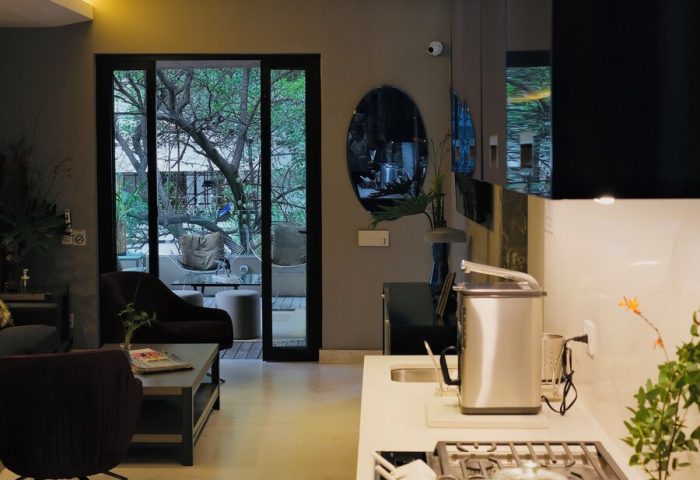 Casa Mannach gay-friendly hotel: Interior view of a modern suite with living area, kitchenette, and outdoor patio. Ideal for gay travel.