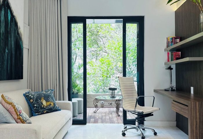 Casa Mannach's gay-friendly hotel room. A modern interior with a sofa, desk, and balcony. Perfect for gay men's travel and relaxation.