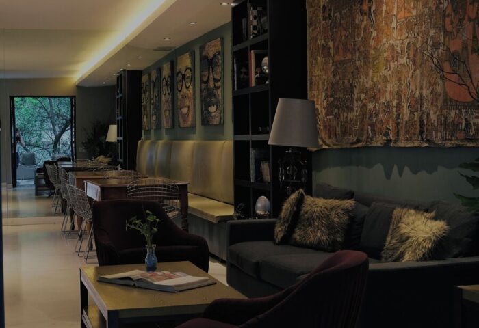 Casa Mannach's stylish lounge area. This gay-friendly hotel features comfortable seating, unique artwork, and a welcoming atmosphere.