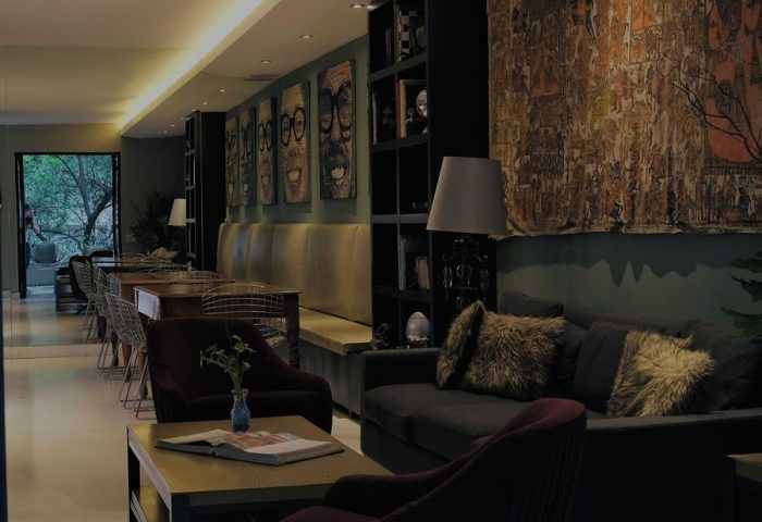 Casa Mannach's stylish lounge area. This gay-friendly hotel features comfortable seating, unique artwork, and a welcoming atmosphere.