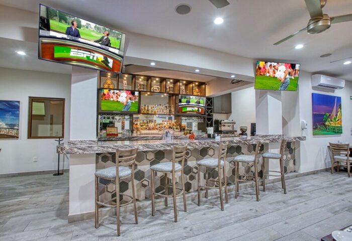 Casa Nicole Boutique Hotel's bar. Gay-friendly hotel with TVs, stools, and drinks. A great place to meet other gay men travelers.