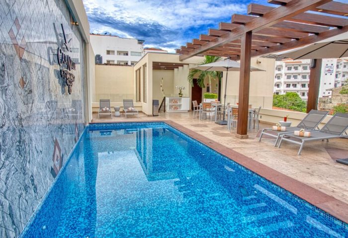 Casa Nicole Boutique Hotel's rooftop pool area. This gay-friendly hotel offers a relaxing oasis with lounge chairs and dining.