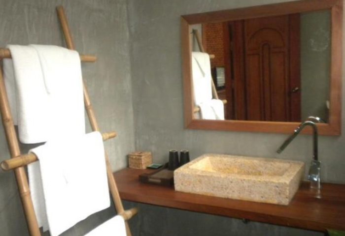 Casa Villa Independence gay-friendly hotel bathroom. Stone sink, bamboo towel rack, and mirror. Modern design.