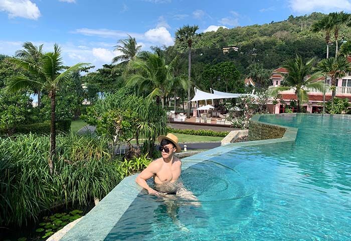 Gay man at Centara Grand Beach Resort Phuket. Relaxing in the pool at this gay-friendly hotel. Tropical paradise, vacation vibes.