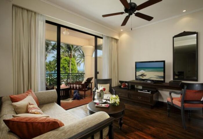 Centara Grand Beach Resort Samui suite. Gay-friendly hotel room with balcony, ocean view, seating area, and TV. Luxury gay travel.