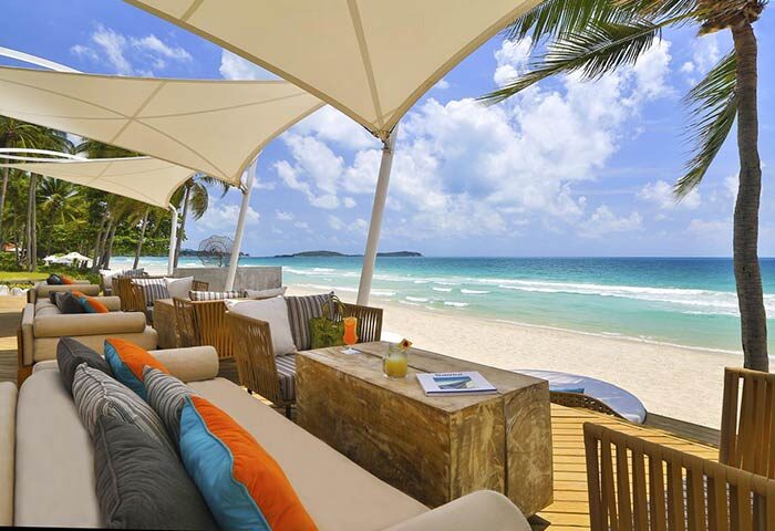 Beachfront lounge at Centara Grand Beach Resort Samui, a gay-friendly hotel. Relaxing seating, ocean views, and tropical cocktails.
