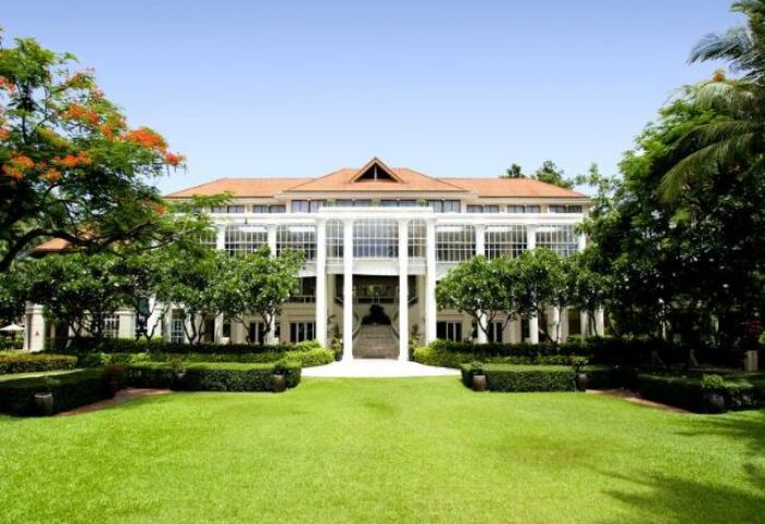 Centara Grand Beach Resort Samui facade. Gay-friendly hotel with manicured lawn and tropical trees. Ideal for gay men's travel in Samui, Thailand.