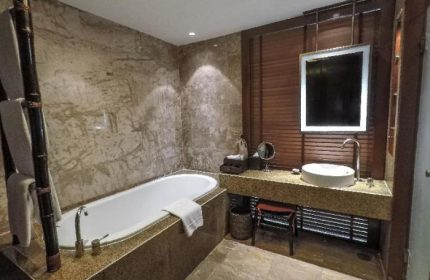 Bathroom at Centara Grand Beach Resort & Villas Krabi, a gay-friendly hotel. Features a bathtub, sink, mirror, and luxurious design.