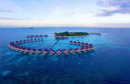 Aerial view of Centara Grand Island Resort & Spa Maldives, a gay-friendly hotel with overwater bungalows. Perfect for gay travel.