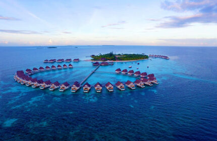 Aerial view of Centara Grand Island Resort & Spa Maldives, a gay-friendly hotel with overwater bungalows. Perfect for gay travel.