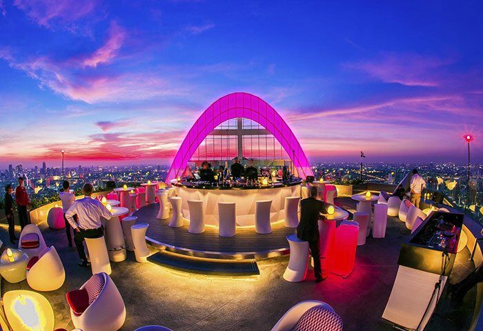 Rooftop bar at Centara Grand at Central World Hotel, a gay-friendly SHA-Certified hotel in Bangkok, Thailand, with city views at sunset.