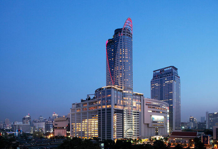 Centara Grand at Central World Hotel, a gay-friendly, SHA-certified hotel in Bangkok. Night view of the modern building.