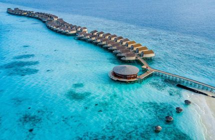 Centara Ras Fushi Resort & Spa, Maldives, a gay-friendly hotel. Overwater bungalows stretch into turquoise water. Perfect for gay travel.