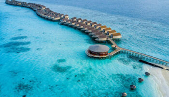 Centara Ras Fushi Resort & Spa, Maldives, a gay-friendly hotel. Overwater bungalows stretch into turquoise water. Perfect for gay travel.
