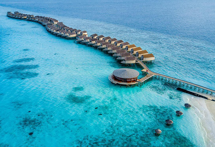 Centara Ras Fushi Resort & Spa, Maldives, a gay-friendly hotel. Overwater bungalows stretch into turquoise water. Perfect for gay travel.