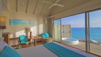 Centara Ras Fushi Resort & Spa Maldives gay-friendly hotel room. Ocean view, jacuzzi, deck. Ideal gay travel destination.