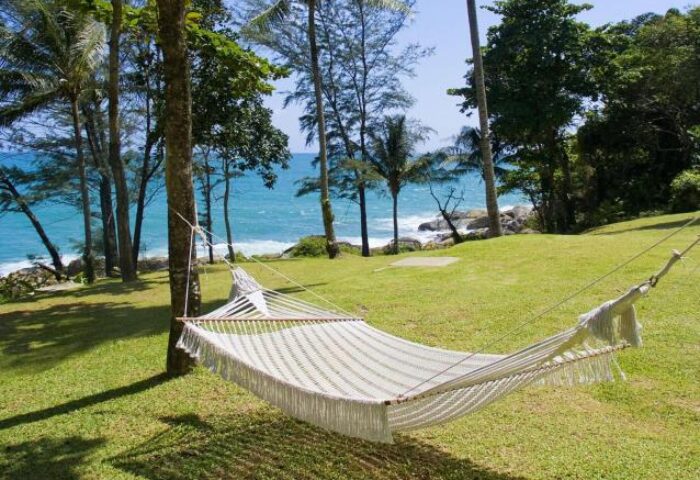 Hammock at Centara Villas Phuket Hotel, a gay-friendly hotel. Ocean view from tropical garden. Perfect for relaxing gay travel in Thailand.