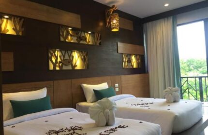 ChaoKoh Phi Phi Hotel & Resort room with twin beds, welcome message, and balcony view. Gay-friendly hotel in Koh Phi Phi, Thailand.