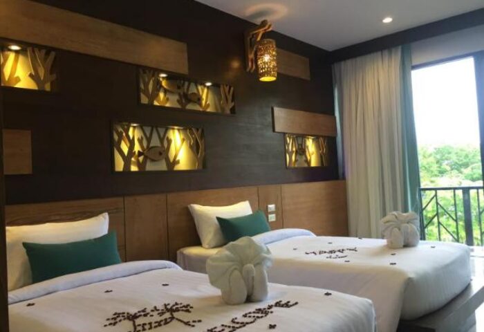 ChaoKoh Phi Phi Hotel & Resort room with twin beds, welcome message, and balcony view. Gay-friendly hotel in Koh Phi Phi, Thailand.