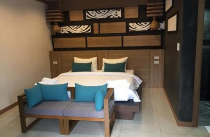 ChaoKoh Phi Phi Hotel & Resort room. Gay-friendly hotel bedroom with king bed, couch, and nautical decor. Ideal gay travel in Thailand.