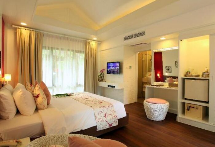 Chaweng Regent Beach Resort gay-friendly hotel room. Luxury bedroom with bed, TV, and bathroom. Ideal for gay men travel in Thailand.
