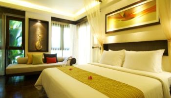 Chaweng Regent Beach Resort room. Gay-friendly hotel with a bed, daybed, and tropical decor. Great for gay travel in Thailand.