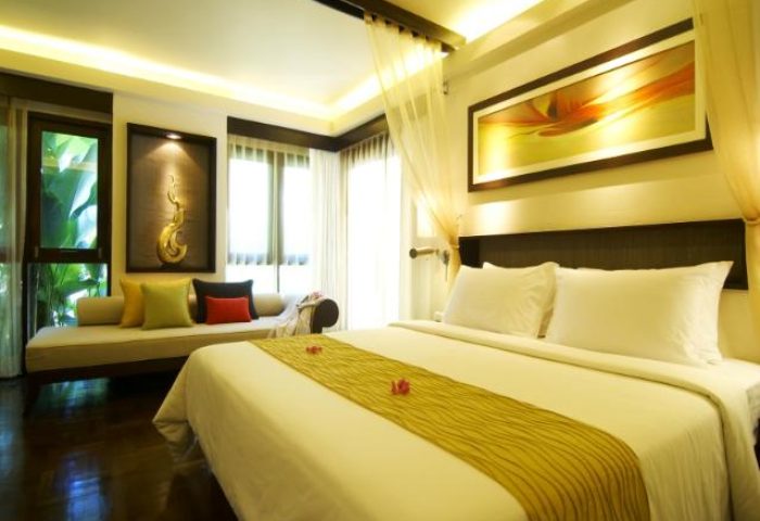 Chaweng Regent Beach Resort room. Gay-friendly hotel with a bed, daybed, and tropical decor. Great for gay travel in Thailand.