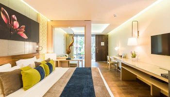 Chaweng Regent Beach Resort room. Gay-friendly hotel with modern decor, king bed, desk, and TV. Ideal for gay travelers seeking luxury.