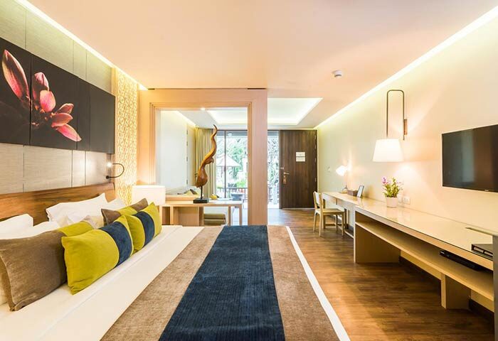 Chaweng Regent Beach Resort room. Gay-friendly hotel with modern decor, king bed, desk, and TV. Ideal for gay travelers seeking luxury.