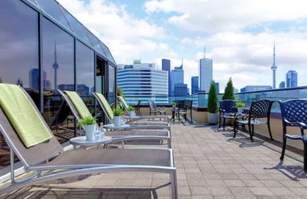 Chelsea Hotel Toronto's rooftop patio. This gay-friendly hotel offers stunning city views. Lounge chairs and seating area. Great for gay travelers.