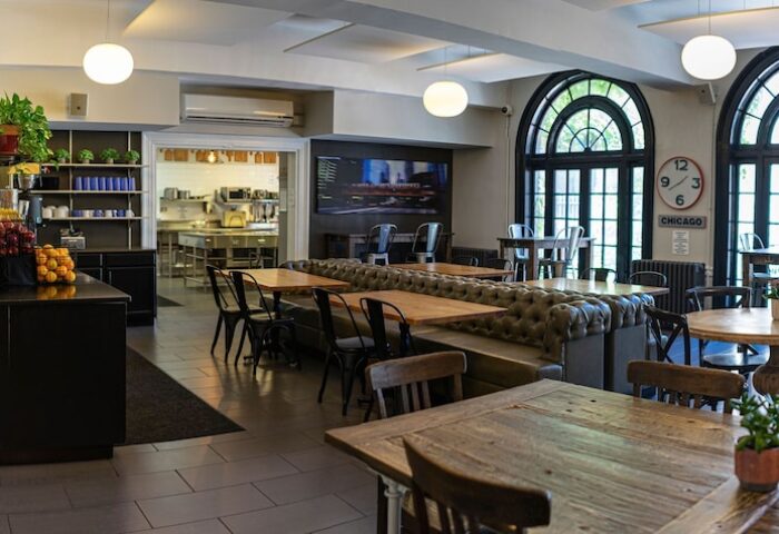 Chicago Getaway Hostel's dining area. Tables and chairs, popcorn machine, and kitchen. A gay-friendly hotel for your Chicago visit.